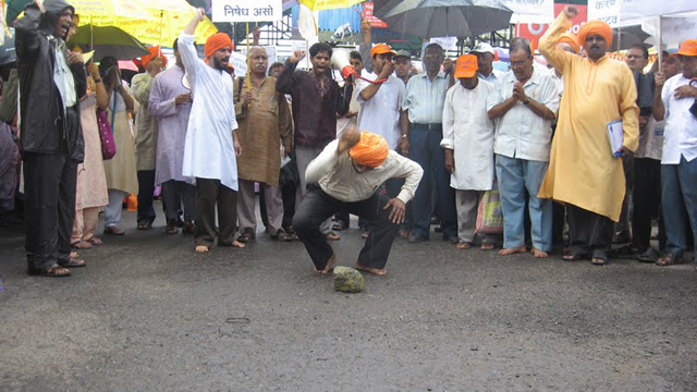 Capt. (Retd.) Dattaram Sawant of Divya Jagruti Trust braking a coconut at beginning of the rally