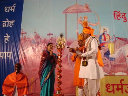 Mrs. Gauri Khilare, Mr. Ramesh Shinde and H. B. P. Anil Maharaj Badave while lighting the Holy lamp