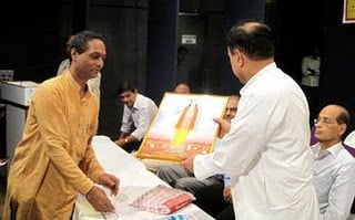 Dr. Swamy receiving the image of Lord Sri Krushna from Mr. Satish Sonar, HJS
