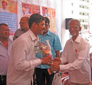 Mr. Mahadev Devale while felicitating Mr. Sagvekar from HJS