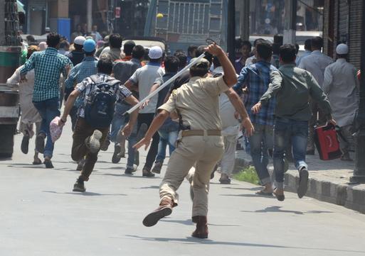 Policemen clash with protestors during protest in Srinagar on Thursday 18, July 2013