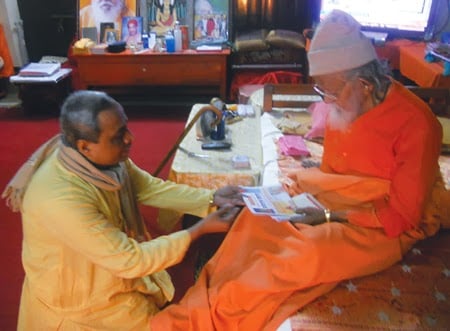 Pujya Dr. Pingle presenting Monthly periodical and Holy texts to Mahant Avaidyanathaji Maharaj 