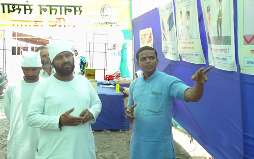 प्रदर्शनी के संदर्भ में जानकारी लेते समय स्वामी हेमंत प्रकाशजी महाराज (मध्य में)