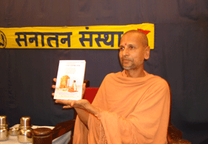 Swami Asangananda Saraswati inagrating spiritual book