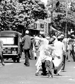 Protesters hurl stones during <br />a bandh in Vadodara on Friday” title=”Protesters hurl stones during <br />a bandh in Vadodara on Friday” /><br />
<br />Protesters hurl stones during <br />a bandh in Vadodara on Friday
</div>
<p>Vadodara:</strong> After the row over controversial paintings by a student of Maharaja Sayajirao University which angered the Sangh Parivar, the institution finds itself in the throes of another controversy over "provocative" sketches.<br />&nbsp;<br />A complaint had been registered against Deepak Shah, a senate member, and four others for allegedly pasting the "provocative" sketches, police said. </p>
<p>The complaint was registered by Farid Lakhijwala after "derogatory" sketches were found near the D.N. Hall housing the Sanskrit Mahavidyalaya on the campus. </p>
<p><strong>Reward offered</strong> </p>
<p>Mr. Lakhijwala’s complaint said that Mr. Shah had offered a reward of Rs.1 lakh to anyone making an artwork on Prophet Mohammed during the recent unrest at university campus over the controversial exhibition by Chandramohan, a student of the Fine Arts Department, which invited the ire of saffron outfits.<br />&nbsp;<br />Police Inspector K.B. Jadeja said they are trying to trace the originals of the sketches."The sketches seem to be the handiwork of persons wanting to vitiate the atmosphere in the city and investigations will expose it," Police Commissioner P.C. Thakur said. </p>
<p>Meanwhile, the owner of a local news channel Ajay Dave and photographer Maulik Patel were beaten up by people when the duo had gone to take pictures of the sketches. </p>
<p><strong>Latest Updates</strong></p>
<p>Furore over sketches depicting Prophet Mohammed in the nude found in M S University campus on Wednesday night spilled over on the streets of vadodara on Friday afternoon. </p>
<p>Mob belonging to the Muslim community pelted stones on the police and media persons to vent ire against the sketches. Later in the night, fresh violence broke out again at 9.30. </p>
<p>Stone pelting was reported in Sultanpura area in Wadi, Junighadi near Panigate and Madanjhampa Road. Mobs were on the streets and the police had to rush to these spots to bring the situation under control. </p>
<p>The mob violence was sparked off after prayers at Jumma Masjid in Mandvi area of the city. A mob came out on the streets and held demonstrations against the sketches. </p>
<p>Some of the protestors were waving posters of Osama bin Laden. Police commissioner P C Thakur was also mobbed by the demonstrators. Violence spilled over in the vicinity of Jamnabai Hospital near Mandvi and Limvali Masjid in Yakutpura area of the city. </p>
<p>Thakur said that the stone-pelting in this area was in reaction to the detention of persons who were up to mischief near Jumma Masjid."However, the police was the target of the mob. The violence was not communal in nature,"Thakur said. A state transport bus was also targeted in Ladwada area near Jamnabai Hospital. </p>
<p>Windscreens and window panes of the bus were shattered by pelting stones on it. Three teargas shells had to be lobbed in Ladwada to disperse the mobs. A teargas shell was also lobbed near Limwali Masjid in Yakutpura to disperse mob there. </p>
<p>While computer printouts giving the call of a ‘bandh’ to protest against the sketches were pasted at several places in the walled city as well as on several autorickshaws on Thursday and Friday, no person or organisation claimed responsibility for the call. </p>
<p>Several community leaders, in fact, urged people to refrain from enforcing the call. In the afternoon, some youths were seen asking establishments to close down in Raopura area. The call, however, evoked some response only in select pockets. </p>
<p>Shops opened in most of these areas late in the evening after the situation became normal. Patrolling and vigil has been intensified in the sensitive areas of the city. </p>
<p>Ref. <br />– <a href=