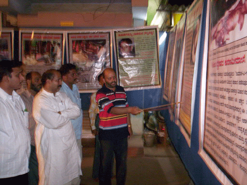 HJS member explaining about photos to MLA & others