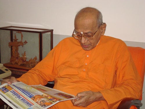 Swami Harshanandji Maharaj keenly going through Monthly English Sanatan Prabhat