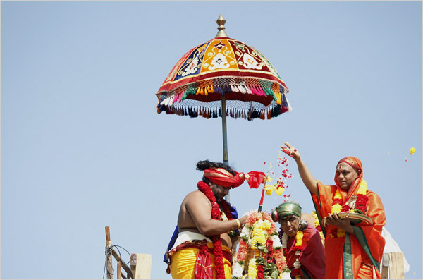 Preists performing ritual on newly built towers of Lord Ganesh Temple
