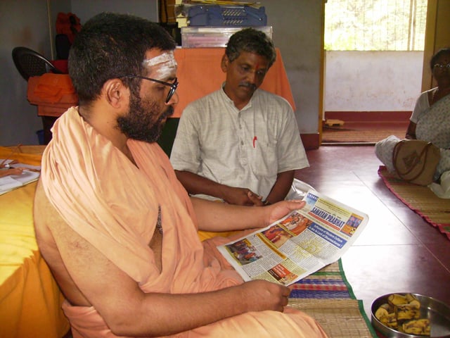 English Sanatan Prabhat being presented to Swami Chidanandapuriji
