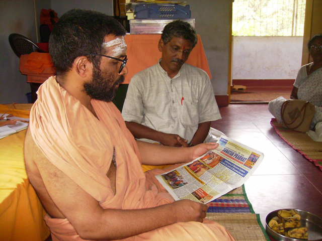 English Sanatan Prabhat being presented to Swami Chidanandapuriji