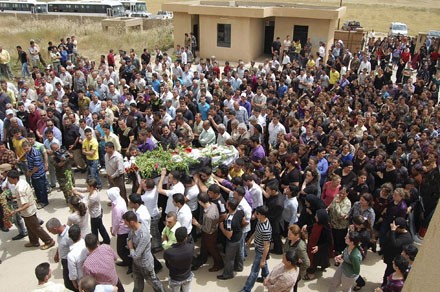 Mourners gather around the coffin of Sandy Shabib Zahri, a Christian student murdered in a bomb atta Mourners gather around the coffin of Sandy Shabib Zahri, a Christian student murdered in a bomb atta
