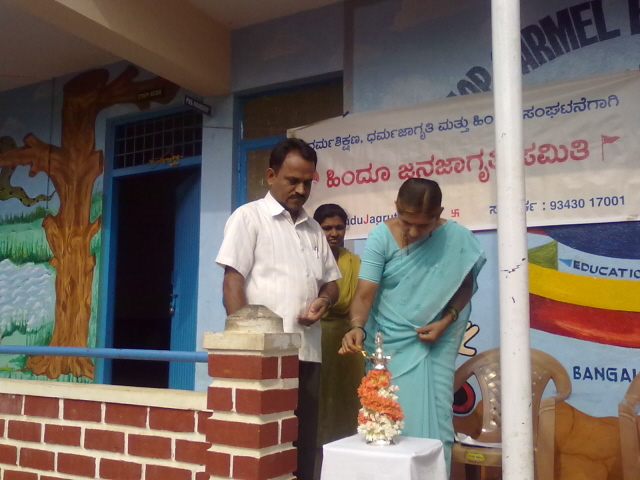 Inauguration of the program by lighting a Samai (an oil lamp) by Mrs. Rao of HJS