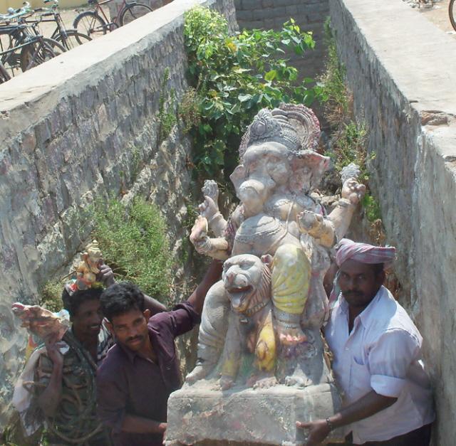 Labourers removing Sri Ganesh idols from the man-made pond - 2