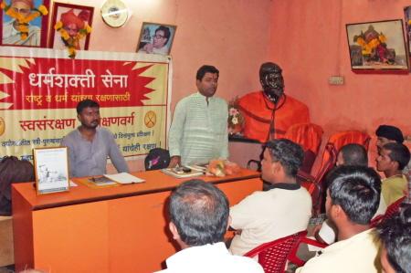 Mr. Prasad Surve (standing) addressing to the devout Hindus; Mr. Abhijit Bhojane (sitting)