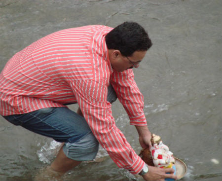 Devotees immersed Ganesh Idols in flowing river water