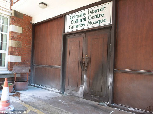 This scorched door of the Mosque shows damage caused by the firebomb attack This scorched door of the Mosque shows damage caused by the firebomb attack
