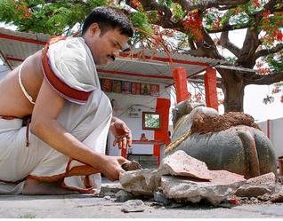 Priest of the temple removing stones from the damaged site