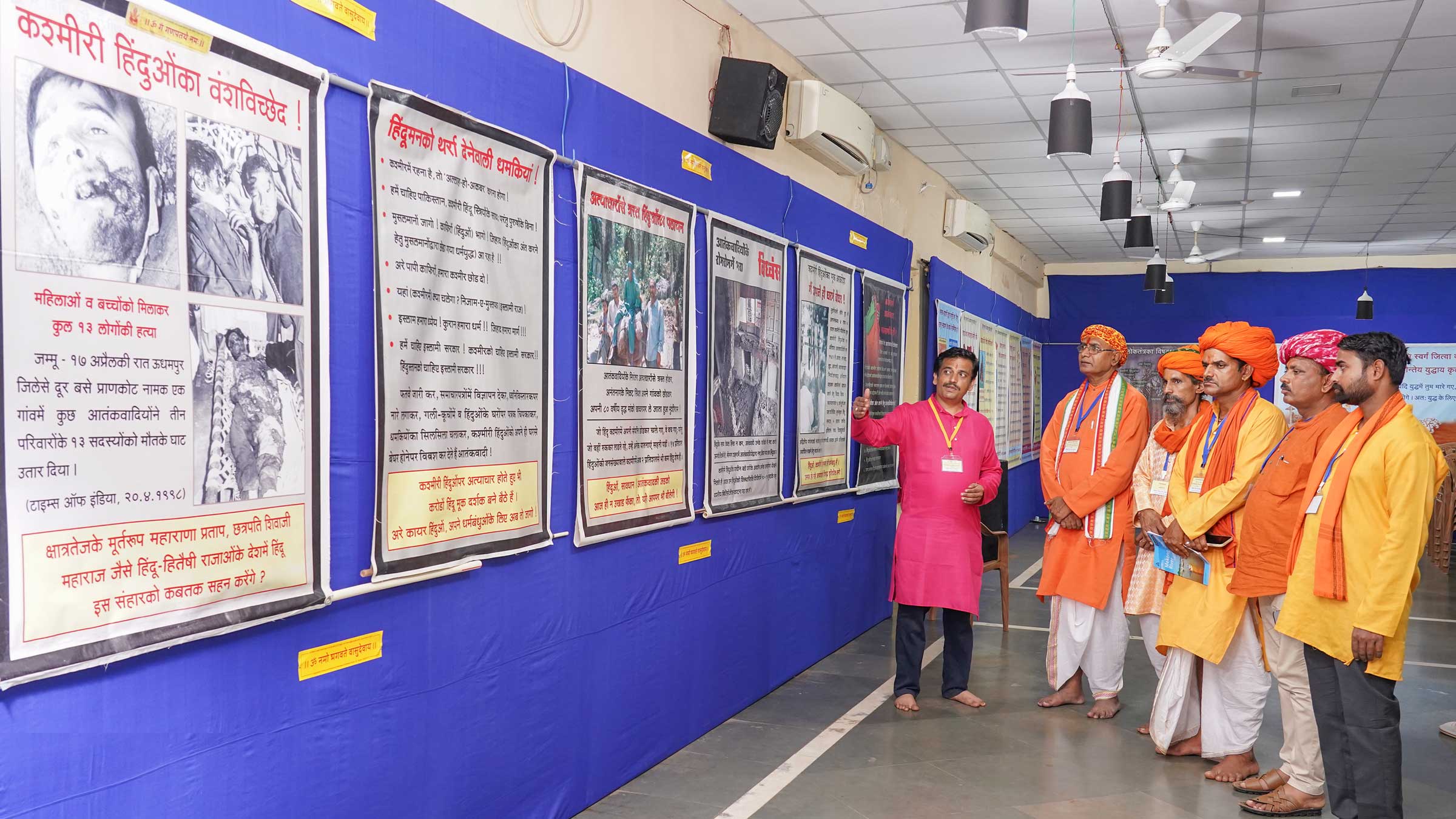Volunteers of Hindu Janajagruti Samiti showing the Devout Hindus posters in an exhibition that provides information on the atrocities Kashmiri Hindus have faced